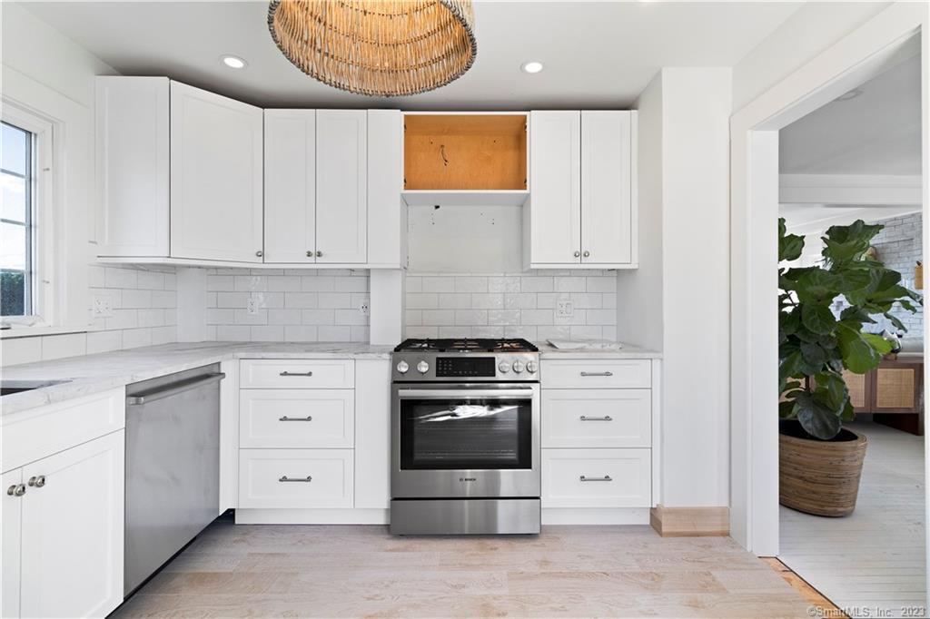 19 Soundview Drive Westport, CT 06880 - Photo 17 of 40 a kitchen with white cabinets and white appliances