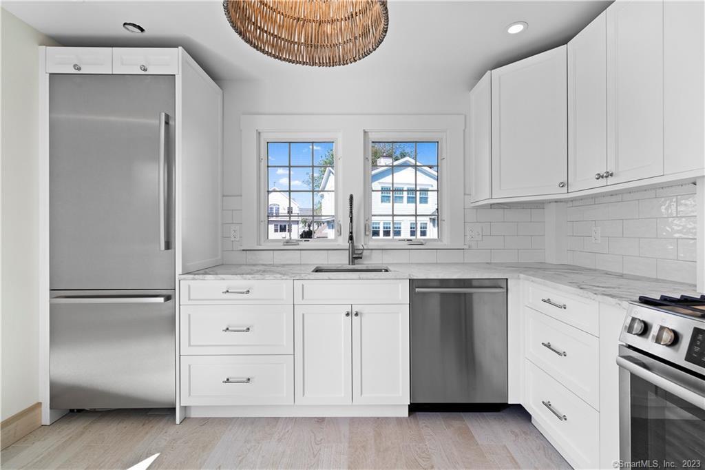 19 Soundview Drive Westport, CT 06880 - Photo 18 of 40 a kitchen with granite countertop white cabinets and white appliances