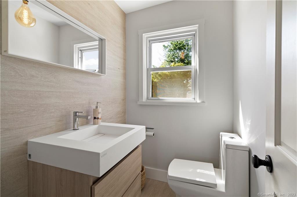 19 Soundview Drive Westport, CT 06880 - Photo 19 of 40 a bathroom with a sink toilet and a mirror