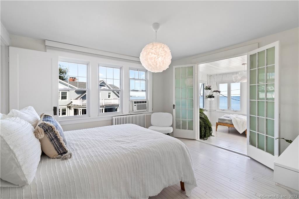 19 Soundview Drive Westport, CT 06880 - Photo 22 of 40 a bedroom with a large bed and a large window