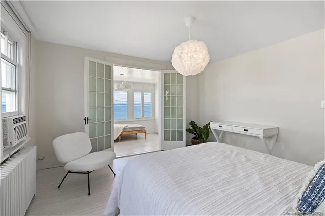 a bedroom with a bed and a chandelier