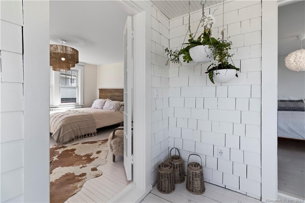 19 Soundview Drive Westport, CT 06880 - Photo 25 of 40 a bedroom with a bed and a potted plant