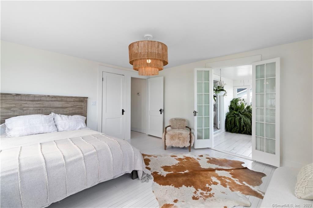 19 Soundview Drive Westport, CT 06880 - Photo 26 of 40 a bedroom with a bed and a chandelier