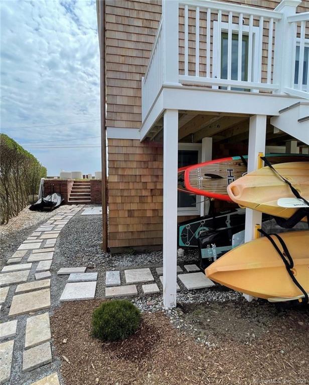19 Soundview Drive Westport, CT 06880 - Photo 31 of 40 a backyard of a house with barbeque oven table and chairs