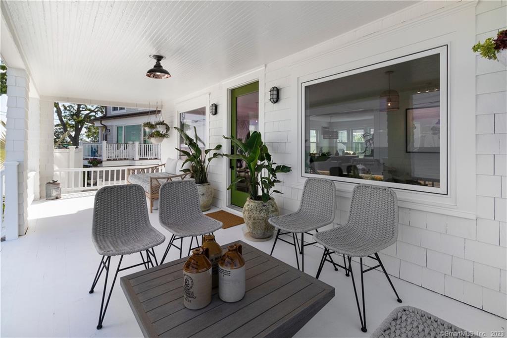 19 Soundview Drive Westport, CT 06880 - Photo 33 of 40 a dining room with furniture a potted plant and wooden floor