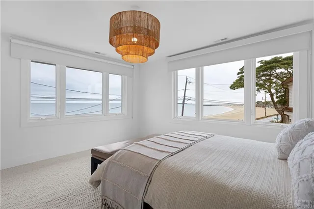 a bedroom with a bed and a large window