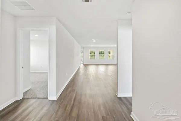a view of an empty room and wooden floor