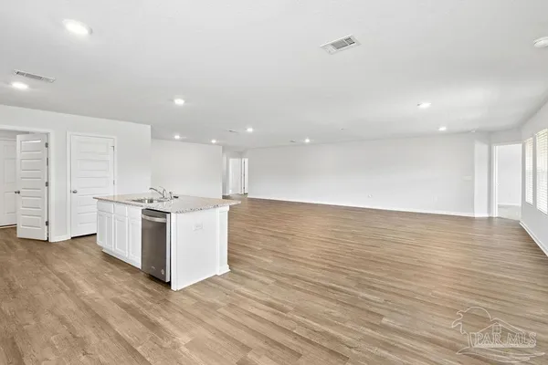 a view of kitchen with granite countertop cabinets and wooden floor