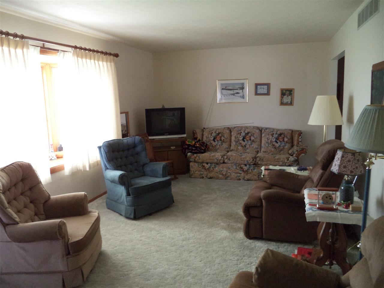 14105 Rowley Road Durand, IL 61024 - Photo 16 of 24 a living room with furniture and a flat screen tv