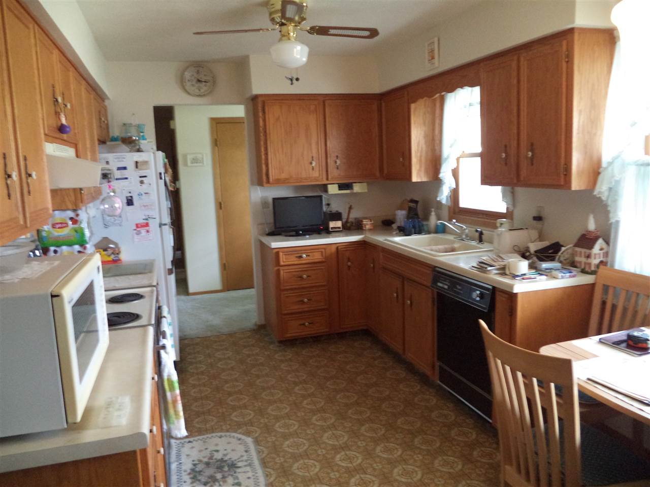 14105 Rowley Road Durand, IL 61024 - Photo 17 of 24 a kitchen with a sink stove and cabinets