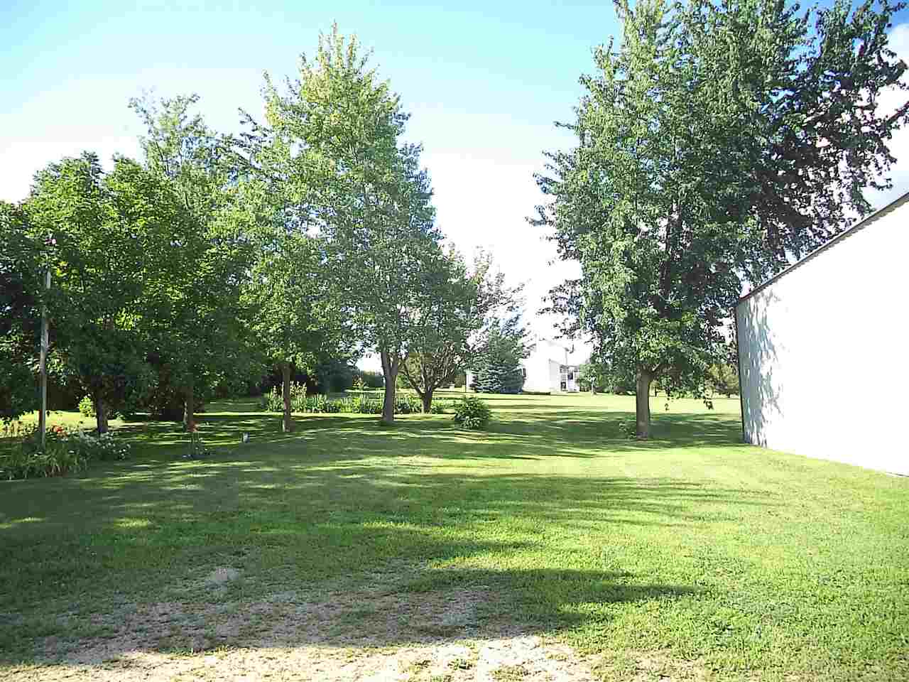 14105 Rowley Road Durand, IL 61024 - Photo 8 of 24 a grassy field with trees in the background