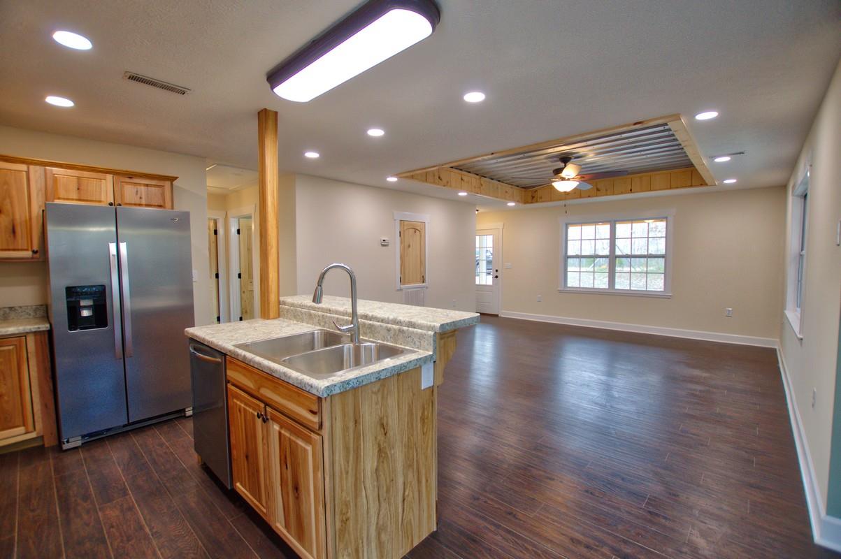 316 Talbert Road Morrison, TN 37357 - Photo 4 of 19 a kitchen with stainless steel appliances granite countertop a sink a refrigerator a stove and a wooden floors