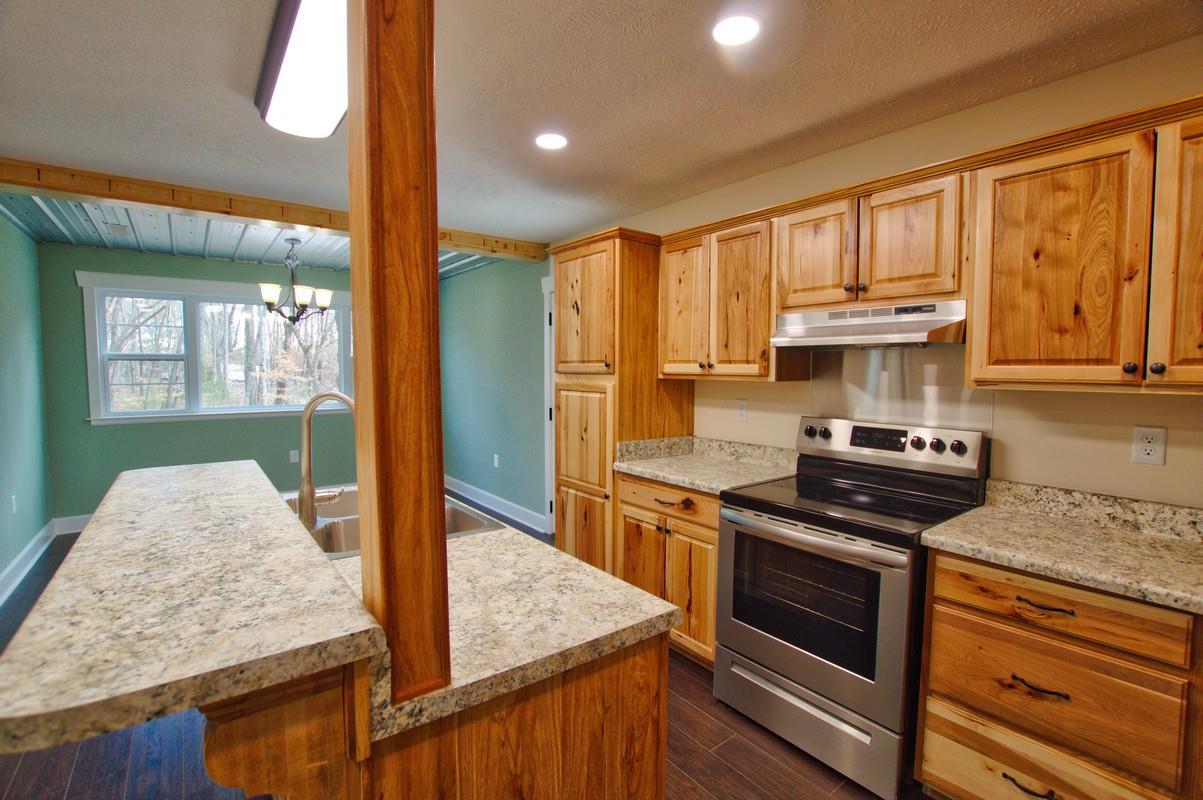 316 Talbert Road Morrison, TN 37357 - Photo 7 of 19 a kitchen with stainless steel appliances granite countertop a stove a sink and a microwave