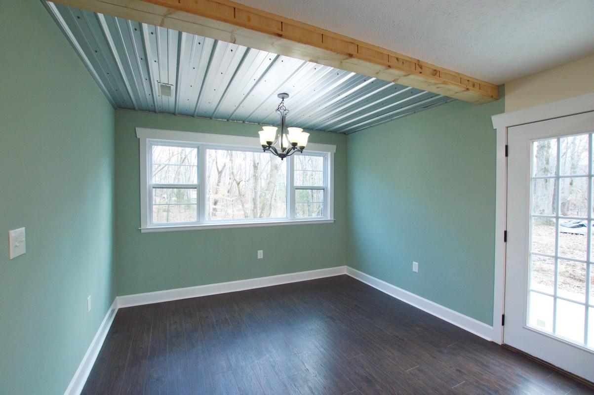 316 Talbert Road Morrison, TN 37357 - Photo 8 of 19 an empty room with wooden floor and windows