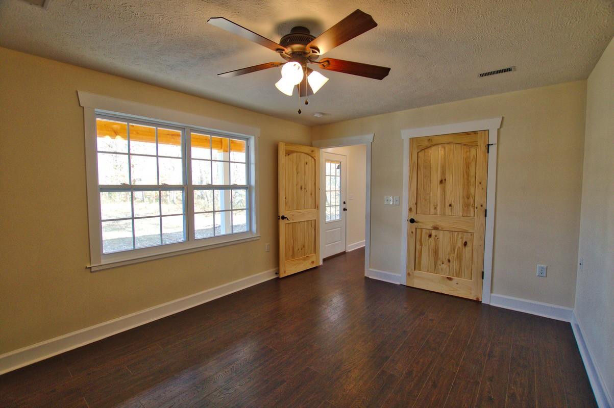 316 Talbert Road Morrison, TN 37357 - Photo 9 of 19 a view of an empty room with a window and wooden floor