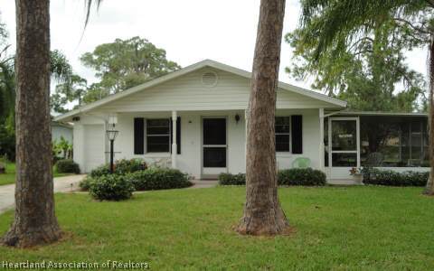 203 Longview Road Sebring, FL 33870 - Photo 11 of 12 a front view of a house with a garden and porch