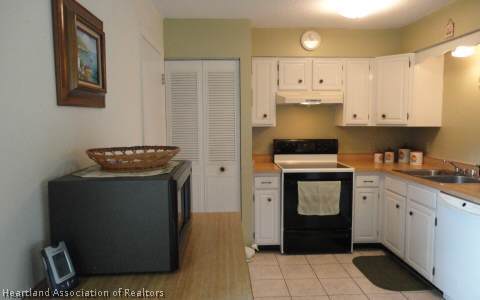 203 Longview Road Sebring, FL 33870 - Photo 2 of 12 a kitchen with a refrigerator and a stove