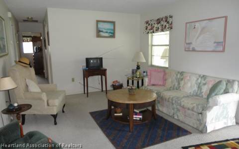 203 Longview Road Sebring, FL 33870 - Photo 3 of 12 a living room with furniture and a potted plant