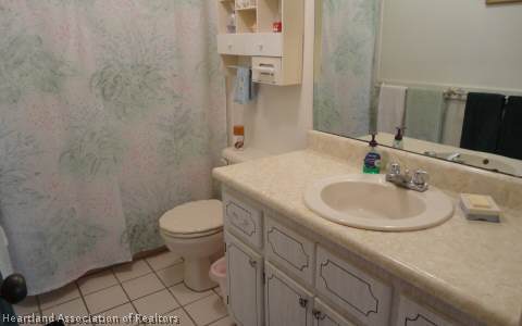 203 Longview Road Sebring, FL 33870 - Photo 7 of 12 a bathroom with a sink toilet and mirror