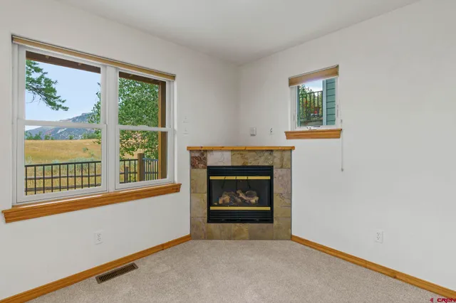 a living room with a fireplace and a window