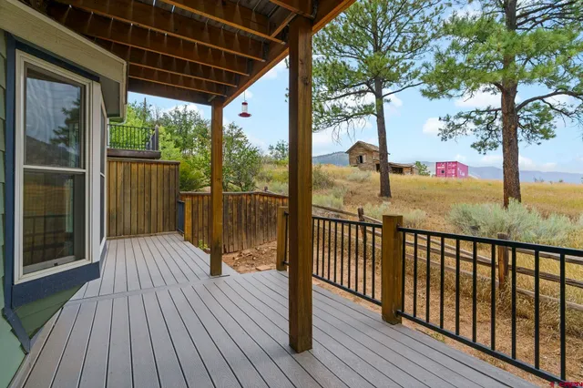 a view of a balcony with wooden floor