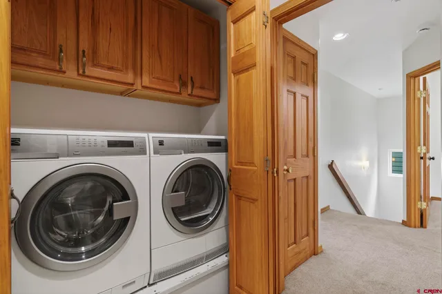 a view of a hallway with washer and dryer