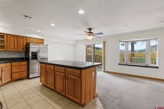 a kitchen with stainless steel appliances granite countertop a sink and cabinets