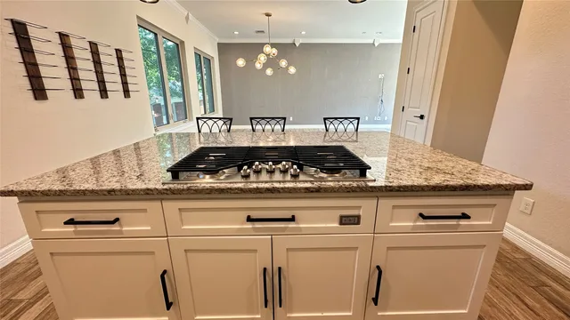 a stove top oven sitting inside of a kitchen