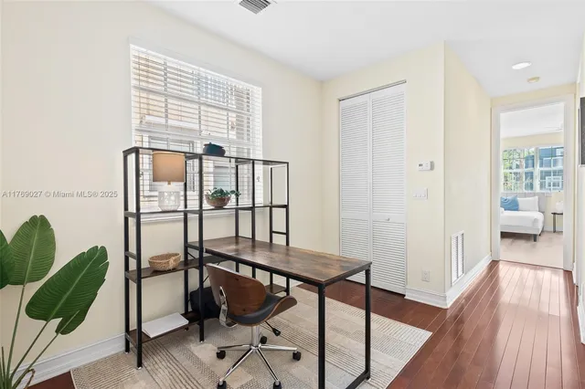 a view of a livingroom with furniture and hardwood floor