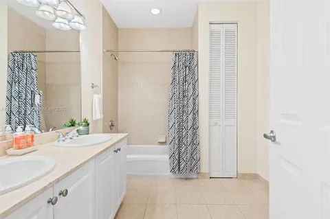 a bathroom with a double vanity sink and a bathtub