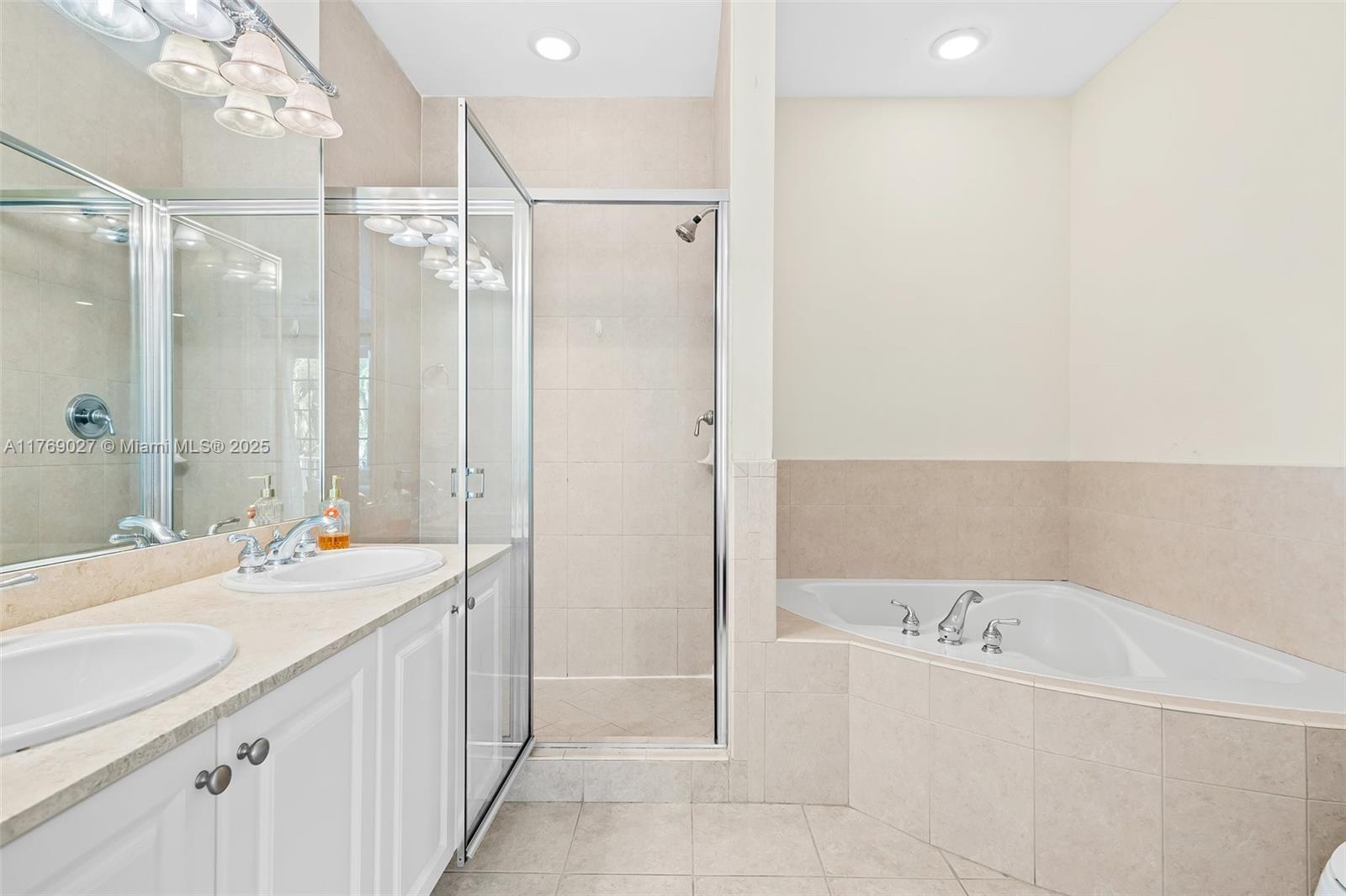 419 Southwest 5th Street, Unit 419 Fort Lauderdale, FL 33315 - Photo 21 of 44 a bathroom with a tub sink shower and mirror