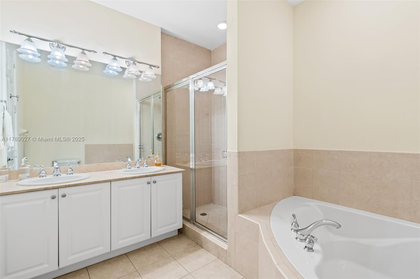 419 Southwest 5th Street, Unit 419 Fort Lauderdale, FL 33315 - Photo 22 of 44 a bathroom with a tub a sink and mirror