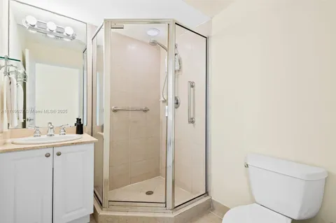 a bathroom with a shower a toilet and a sink