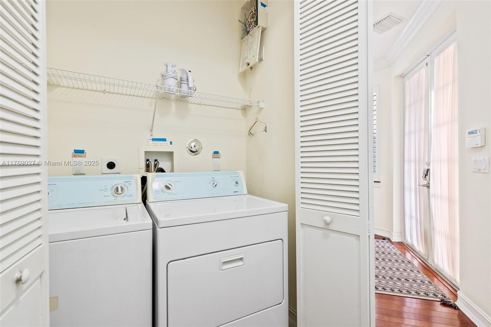 419 Southwest 5th Street, Unit 419 Fort Lauderdale, FL 33315 - Photo 26 of 44 a view of washer and dryer with bathroom in the background