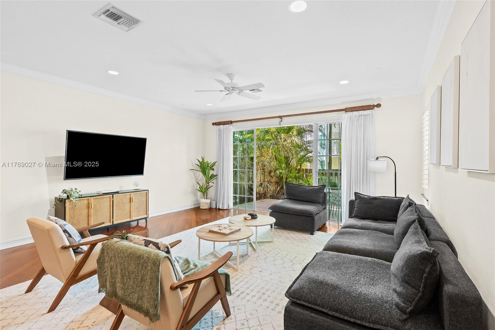419 Southwest 5th Street, Unit 419 Fort Lauderdale, FL 33315 - Photo 3 of 44 a living room with furniture and a flat screen tv