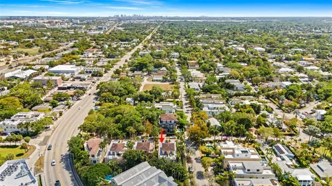 an aerial view of residential houses with city view