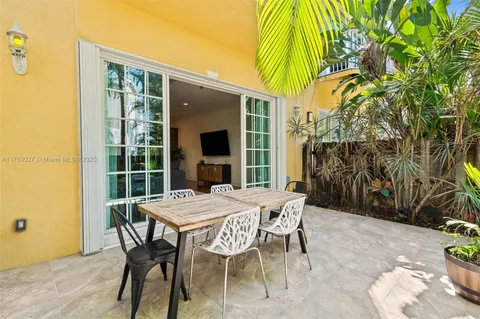 a view of a patio with table and chairs and potted plants