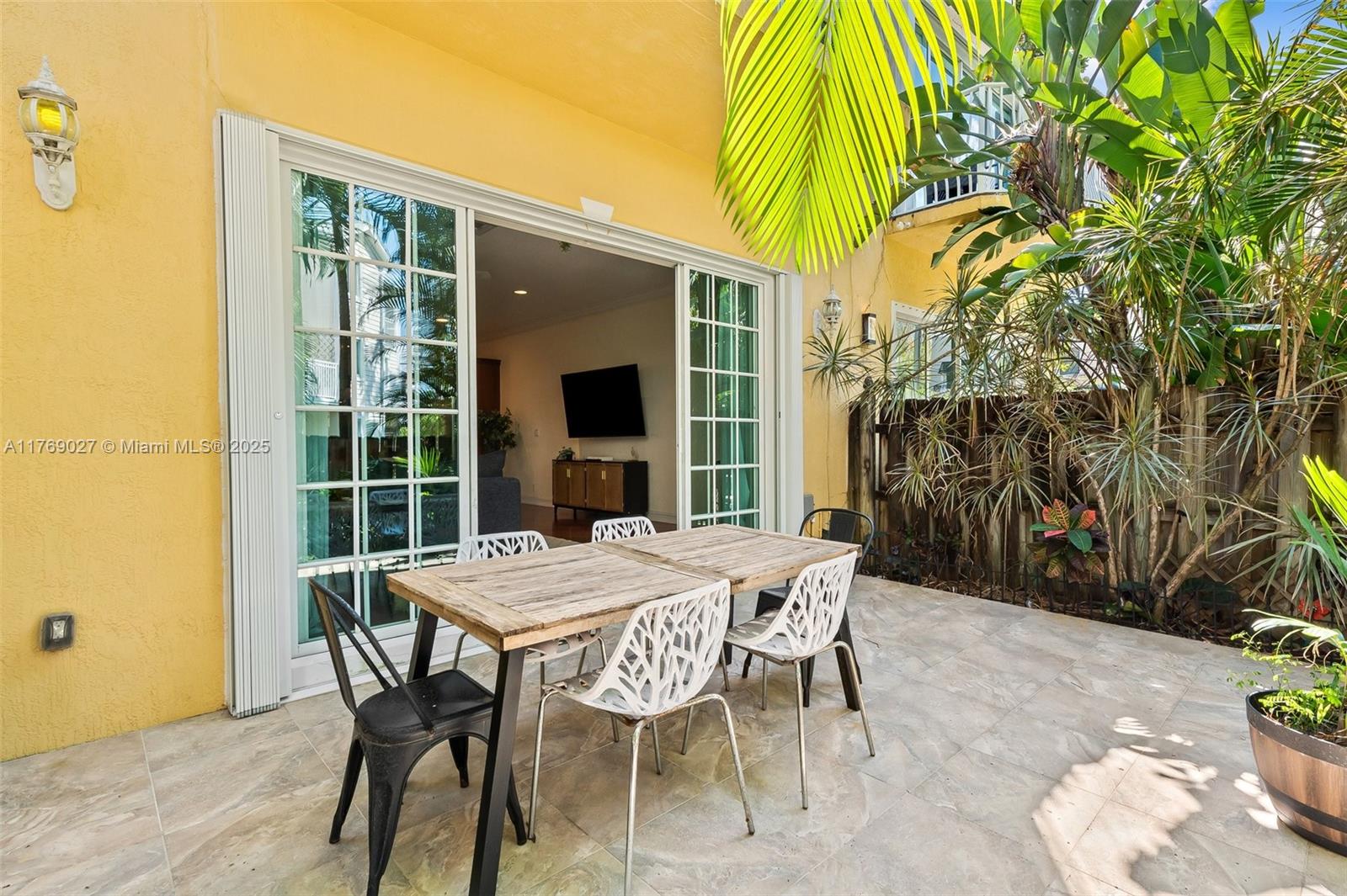 419 Southwest 5th Street, Unit 419 Fort Lauderdale, FL 33315 - Photo 35 of 44 a view of a patio with table and chairs and potted plants