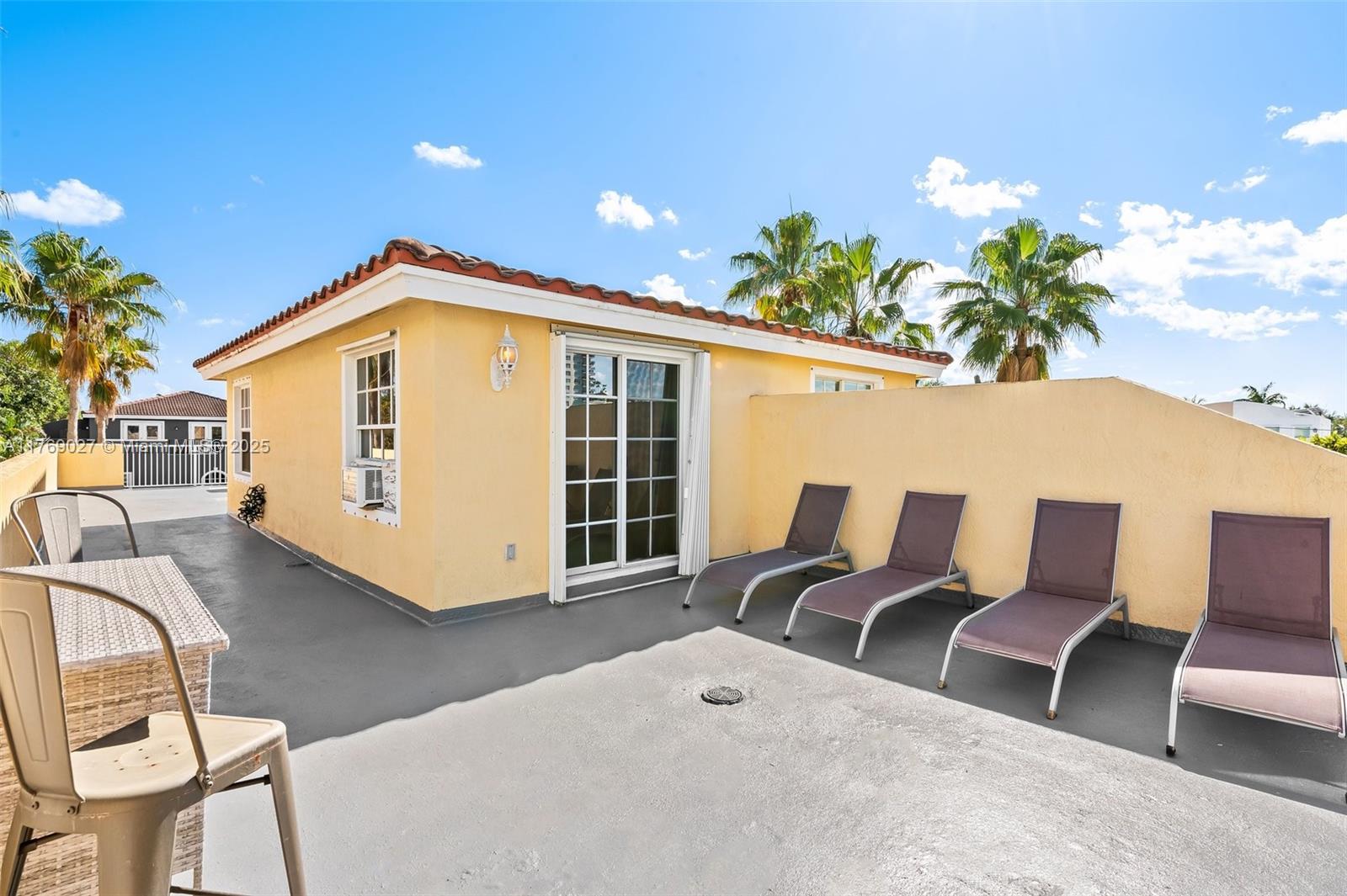 419 Southwest 5th Street, Unit 419 Fort Lauderdale, FL 33315 - Photo 41 of 44 a view of a chairs and table in the back yard