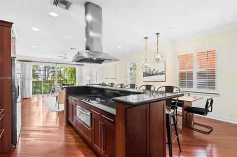 a kitchen with stainless steel appliances granite countertop a stove and a large window
