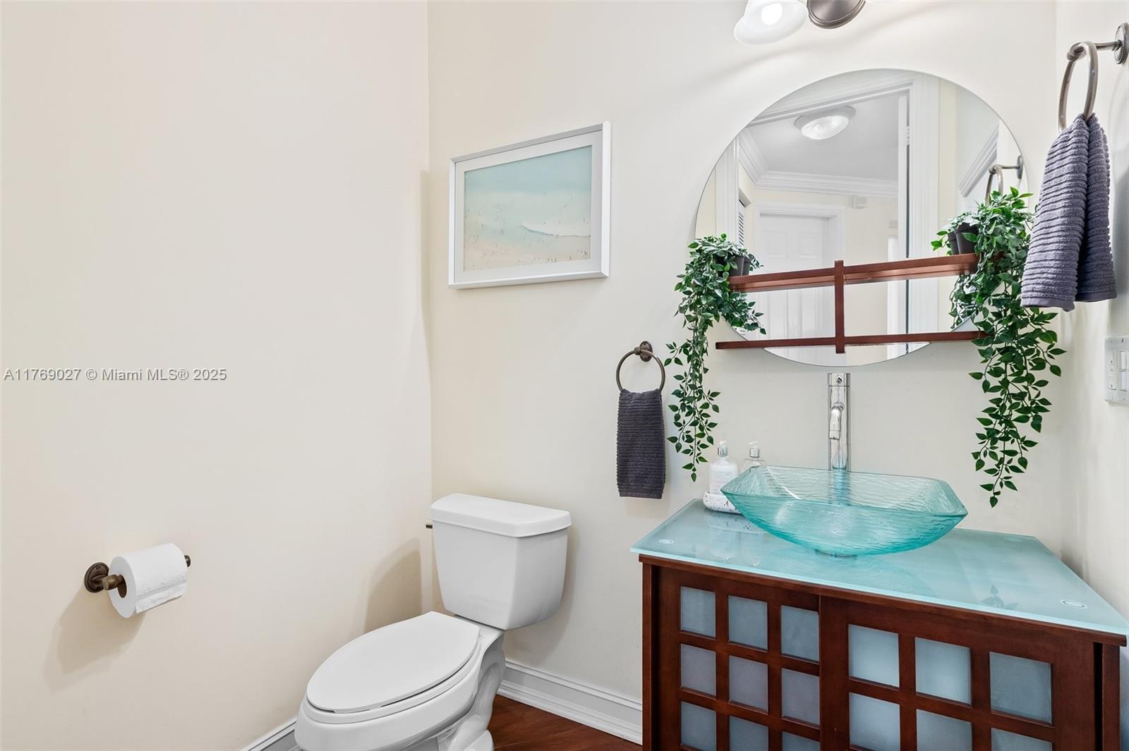 419 Southwest 5th Street, Unit 419 Fort Lauderdale, FL 33315 - Photo 8 of 44 a bathroom with a toilet a sink and mirror