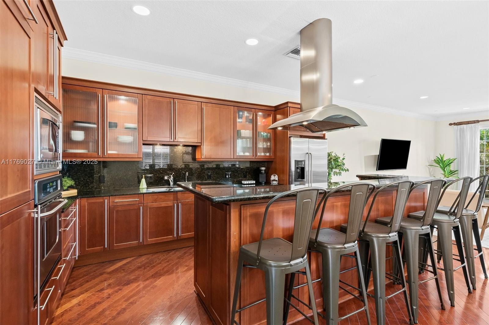 419 Southwest 5th Street, Unit 419 Fort Lauderdale, FL 33315 - Photo 10 of 44 a kitchen with stainless steel appliances granite countertop a stove top oven a sink and a refrigerator