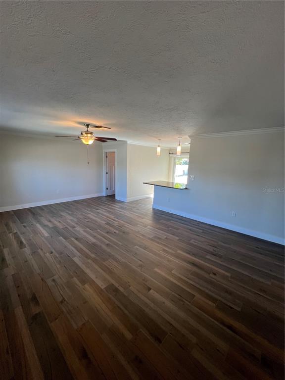 511 West Retta Esplanade Punta Gorda, FL 33950 - Photo 6 of 19 a view of empty room with wooden floor and window