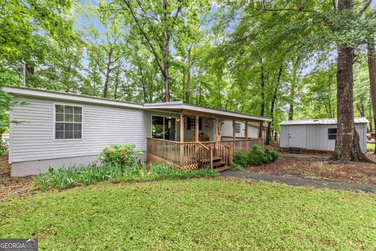 194 Phillips Road Eatonton, GA 31024 - Photo 56 of 57 a view of a house with a yard and large trees