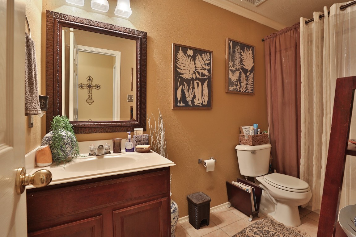 21711 Cascade Hollow Lane Spring, TX 77379 - Photo 11 of 24 a bathroom with a toilet sink and mirror