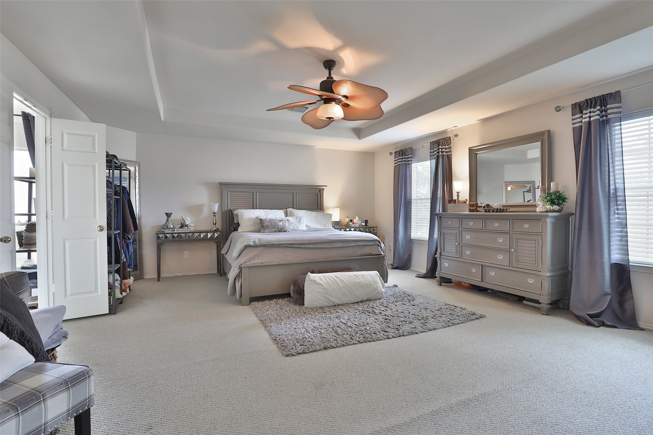 21711 Cascade Hollow Lane Spring, TX 77379 - Photo 13 of 24 a bedroom with a bed a ceiling fan and a dresser