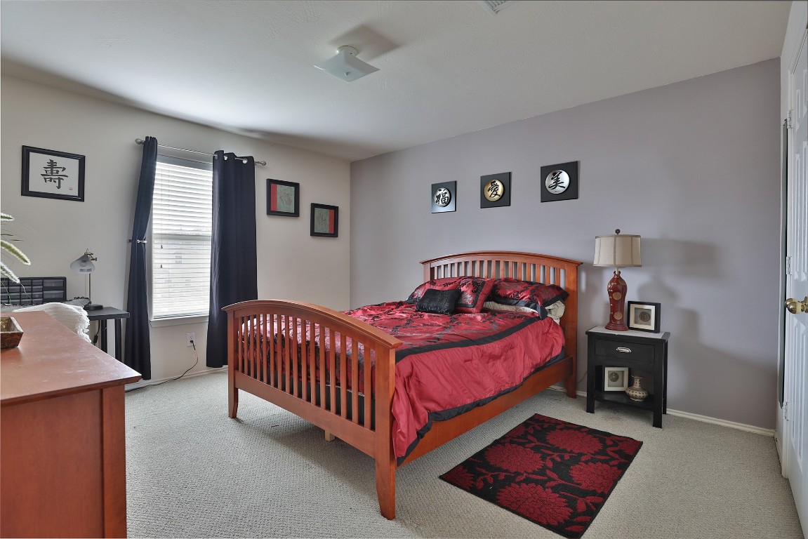 21711 Cascade Hollow Lane Spring, TX 77379 - Photo 19 of 24 a bedroom with a bed and a window