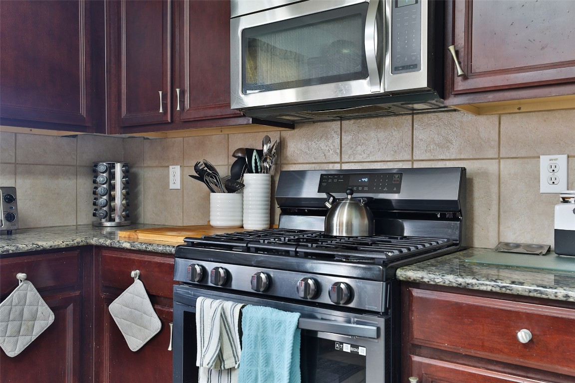 21711 Cascade Hollow Lane Spring, TX 77379 - Photo 7 of 24 a kitchen with granite countertop stainless steel appliances and cabinets