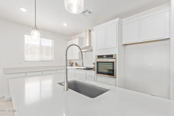 a kitchen with stainless steel appliances a refrigerator sink and cabinets