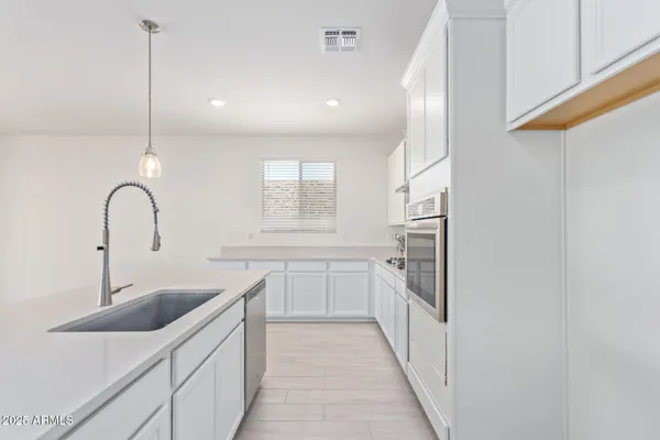 a kitchen with a sink and refrigerator